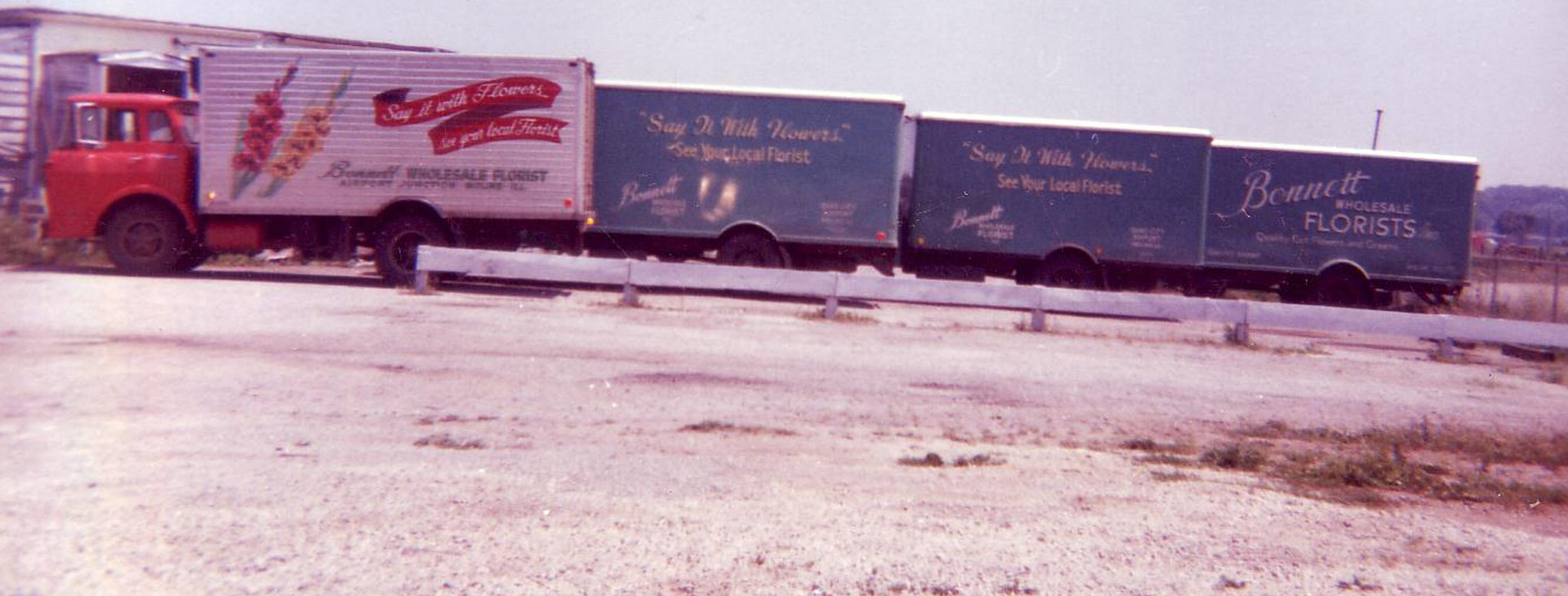 Row of delivery trucks with Bonnett Wholesale Florists branding